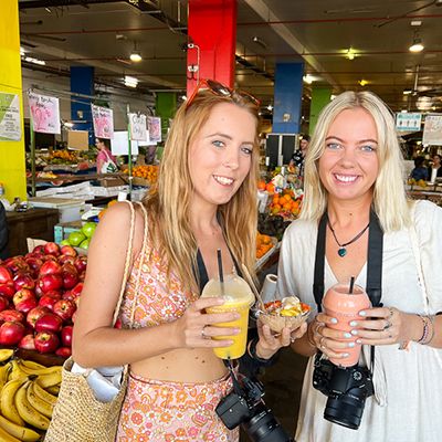 Two women with juices at Cairns fruit market