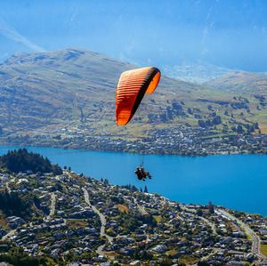 Someone paragliding in front of a beautiful New Zealand backdrop