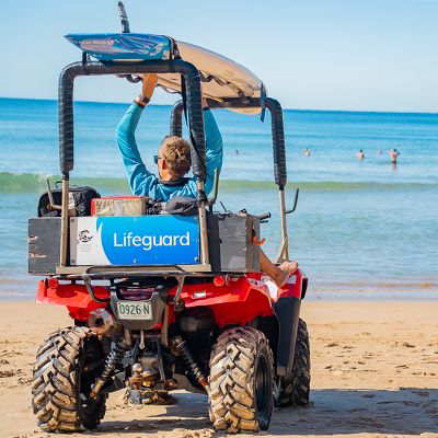 Lifeguard sitting in a beach buggy watching the surf at Bondi
