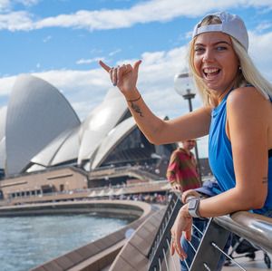 A girl posing in front of the Sydney Opera House