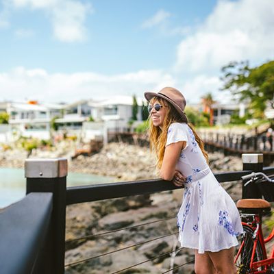 Woman with red bicycle at Airlie Beach boardwalk