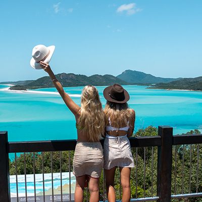 Two girls at hill inlet with backpacks