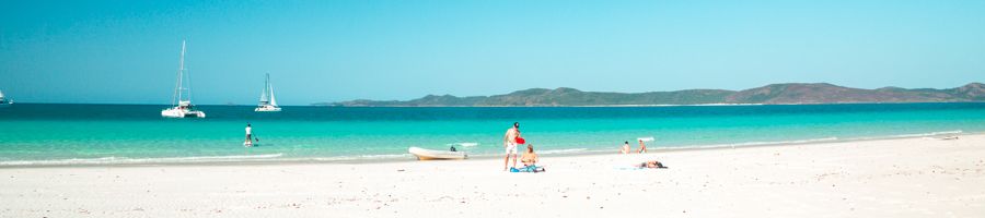 Whitehaven Beach bay with man standing on white sand