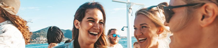 A group of friends laughing together on a boat