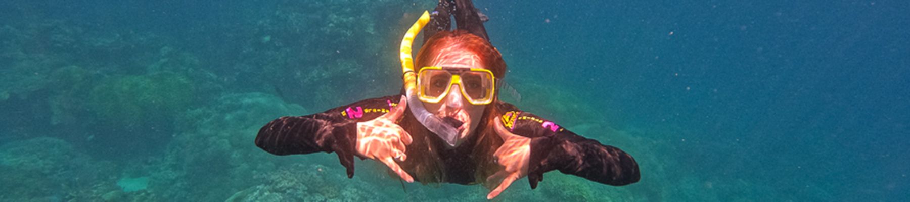 woman snorkelling in the Great Barrier Reef underwater shot