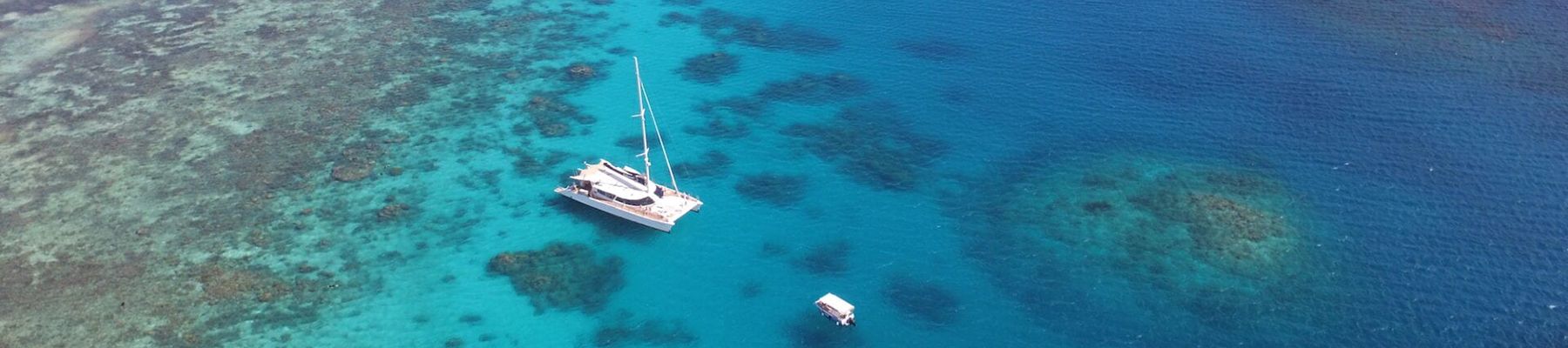 Aerial view of Sailaway VII sailing catamaran in the outer reef