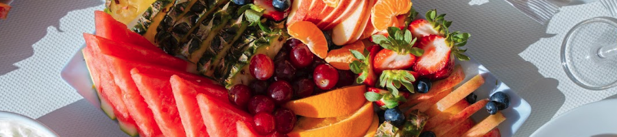 A top down shot of a fruit platter on a table on a boat