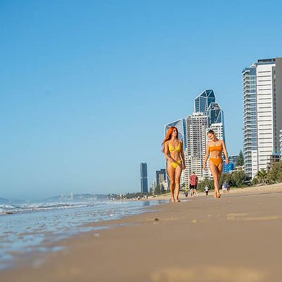 Two women walking on a Gold Coast beach