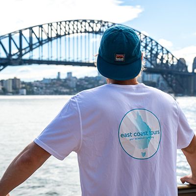 Man in an ECT tshirt looking at the Harbour Bridge