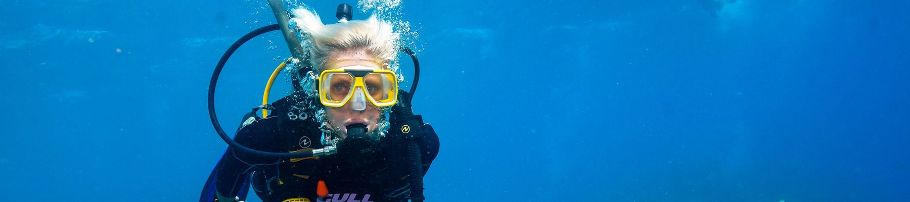 Woman underwater with a scuba tank