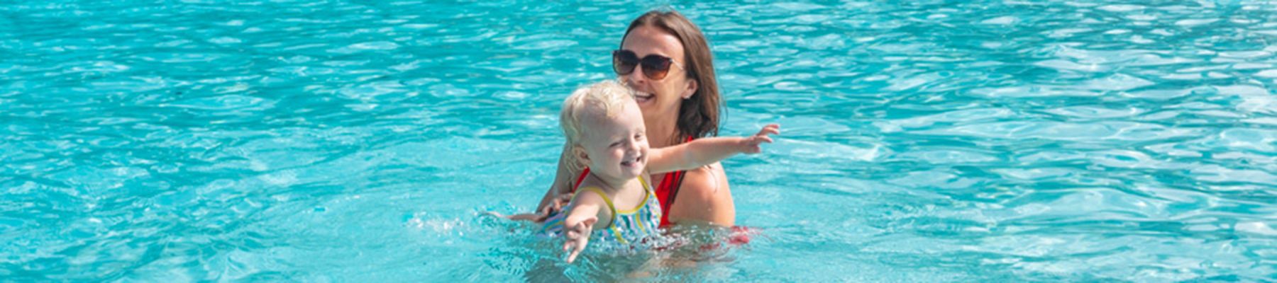 Poolside woman with her child in a pool