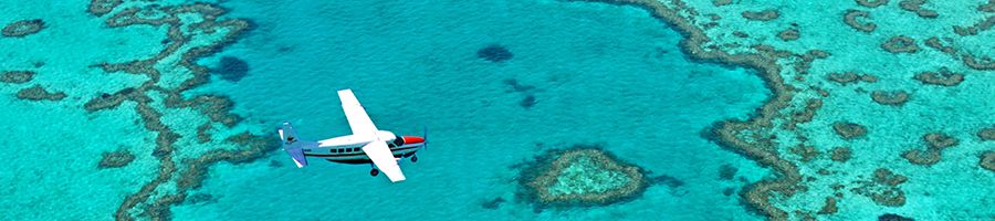 Scenic flight flying over turqouise reefs