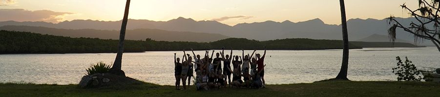 Tour group taking a picture at sunset at Port Douglas