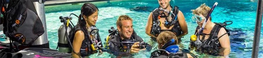 Group of people learning how to dive at a diving training centre