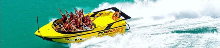 Pioneer jet carving white water into placid blue ocean