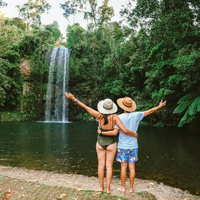 Two people at the Millaa Millaa Falls in swimmers