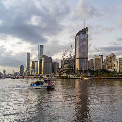 Brisbane city with ferry down the river