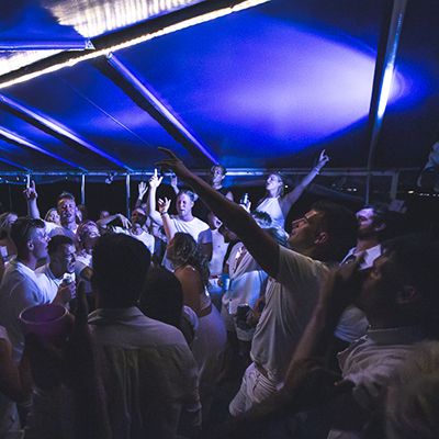 A group of backpackers at a party dancing