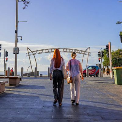 Two people on a walk down Surfers Paradise main strip