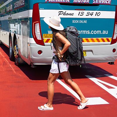 A woman with her backpack at the bus station