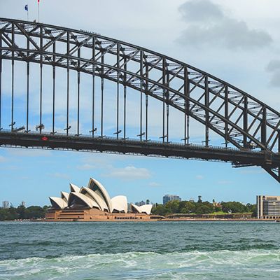 Sydney Harbour Bridge and Opera House with blue sky and water