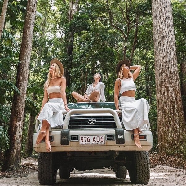 Girls in white sitting atop 4WD on Fraser
