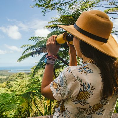 Woman with binoculars looking out over Airlie Beach