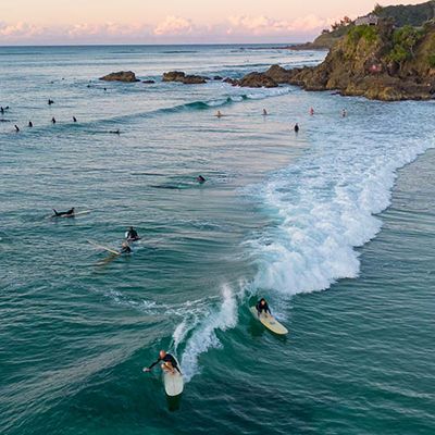 Beach at Byron Bay with many surfers