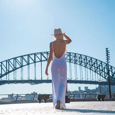 Woman in a white dress standing in front of the Harbiour bridge