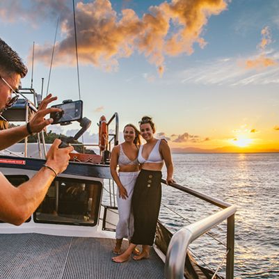 Two people getting a picture taken in the Whitsundays at sunset