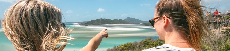 Hill Inlet Lookout with two people looking at the view and pointing
