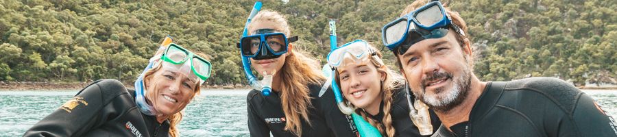A family out amongst the Great Barrier Reef snorkelling