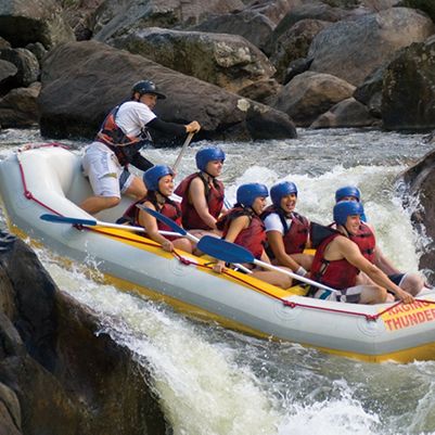Group of people white water rafting on Tully River