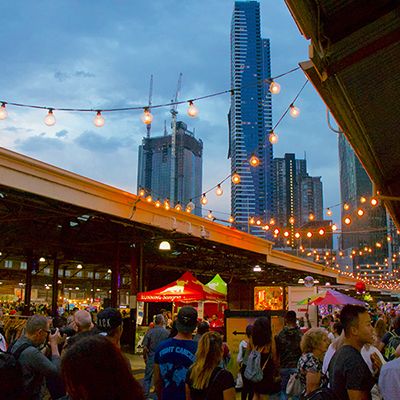 A night market with hanging lights and colourful stalls