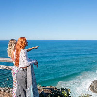 Two people looking out over Byron Bay 