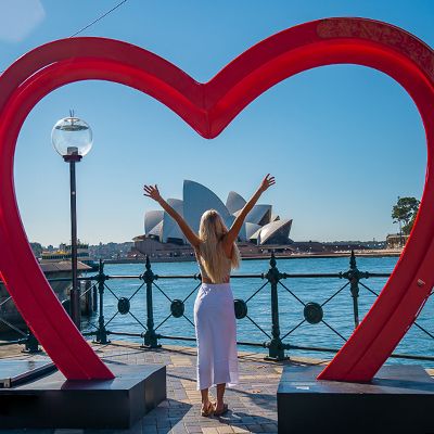 A person with outstretched arms at the Opera House