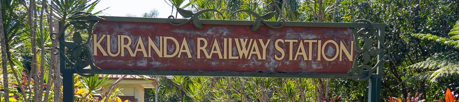 Kuranda Railway sign surrounded by lush greenery