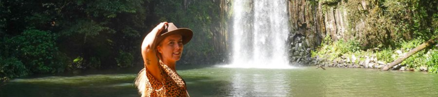 Woman standing in front of Millaa Millaa Waterfall