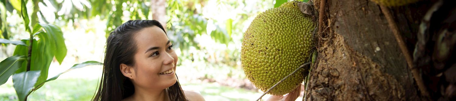 Girl viewing large strange tropical fruit