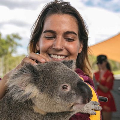 Woman holding a furry koala