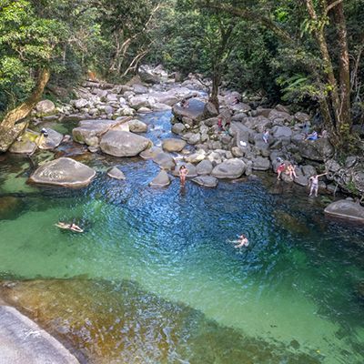 Josephine Falls, Cairns aerial shot with people swimming in a blue waterfall hole