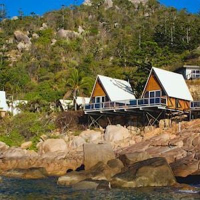 wooden bungalows by the beach on a cliff