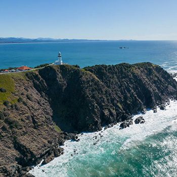 A lighthouse in Byron Bay with blue ocean