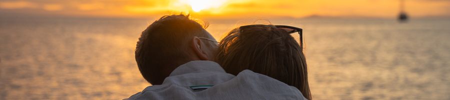 two people watching the sunset on a boat