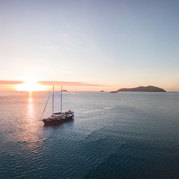 A backpacker boat at sunset on the Whitsunday waters