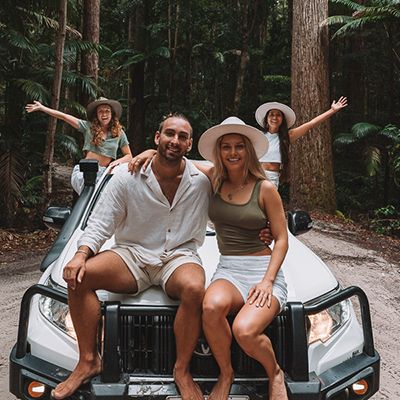 A group of four backpackers on a K'gari 4WD in the forest