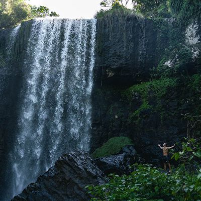 Zillie Falls with a man standing next to the cascades