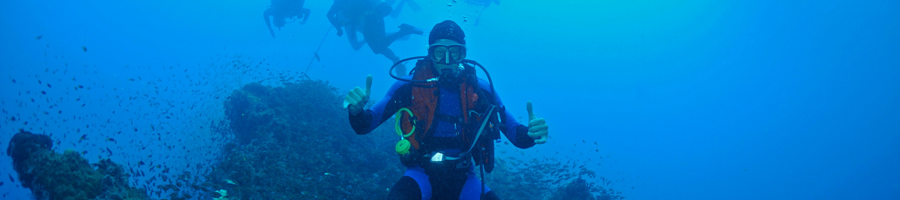 Scuba diver underwater giving two thumbs up