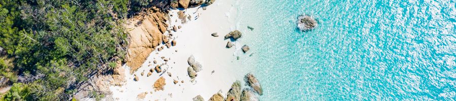 aerial view of white sand beach in the Whitsundays