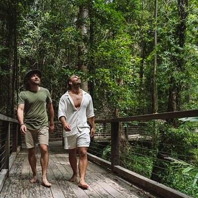 guys walking through rainforest on K'gari